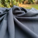 Woman in solid slate blue wide leg pants with matte texture (2)