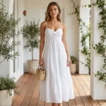 Woman wearing a white sleeveless tiered maxi dress with sweetheart neckline and twist front detail (4)