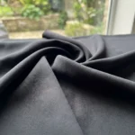 Woman wearing black full length solid wide leg trousers (1)