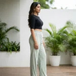 Woman wearing mint green pleated wide leg pants with slight sparkle (3)