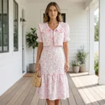 Women’s pink floral embroidered midi dress featuring a ruffled hem, puff sleeves, and a matching button up cropped jacket (2)