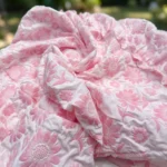 Women’s pink floral embroidered midi dress featuring a ruffled hem, puff sleeves, and a matching button up cropped jacket (3)