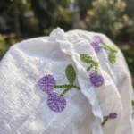 a woman wearing a white tiered midi dress with purple cherry embroidery (4)