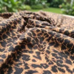 leopard print midi dress with spaghetti straps and a v neckline, featuring a front cutout and back tie detail (3)