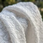 white textured mini dress with sheer yoke and ruffled cap sleeves, featuring a back bow detail (5)