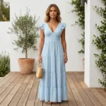 woman wearing a sky blue tiered plisse maxi dress with flutter sleeves and a smocked back detail (1)