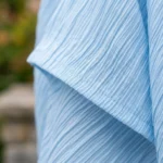woman wearing a sky blue tiered plisse maxi dress with flutter sleeves and a smocked back detail (4)