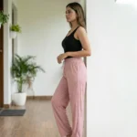 woman wearing dusty pink ribbed straight pants with sparkle details and a white drawstring (1)