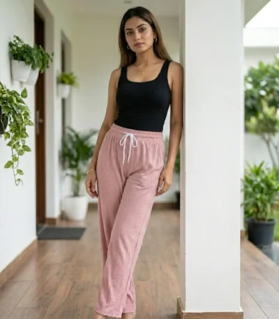 woman wearing dusty pink ribbed straight pants with sparkle details and a white drawstring (3)