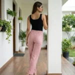 woman wearing dusty pink ribbed straight pants with sparkle details and a white drawstring (4)
