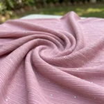 woman wearing dusty pink ribbed straight pants with sparkle details and a white drawstring (5)