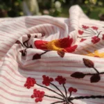 Woman wearing a pink striped half sleeve shirt with floral embroidery (2)