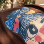 Women's relaxed fit brown t shirt with a colorful character graphic print (1)