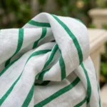 a premium women's white linen long shirt dress with bold green vertical stripes, (3)