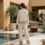 an off white women's co ord set with scattered floral patterns and detailed hem borders (3)