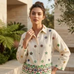 an off white women's co ord set with scattered floral patterns and detailed hem borders (4)