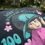 black oversized graphic t shirt featuring a cartoon character print with pink flowers (1)