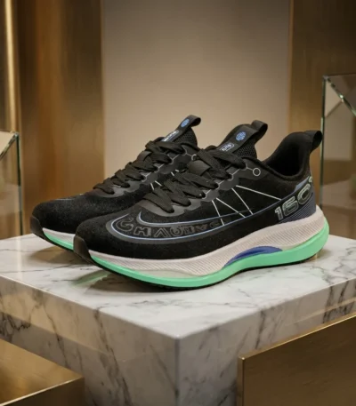 Black athletic running shoe with white midsole and mint green outsole (3)