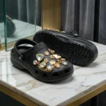 Black slip on womens clogs decorated with gold hardware and crystals (1)