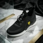 Ferrari black slip on sneaker featuring a yellow shield logo and thick white sole (2)