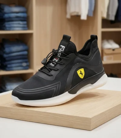 Ferrari black slip on sneaker featuring a yellow shield logo and thick white sole (4)