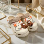 Women cream chunky clogs with brown bear charms, orange stars, and a silver chain strap (1)