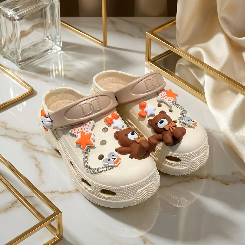 Women cream chunky clogs with brown bear charms, orange stars, and a silver chain strap (1)