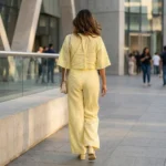 Women wearing a pastel yellow linen tie front short shrug top with wide bell sleeves (1)