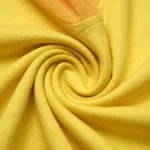 Women's yellow round neck top with sheer puff sleeves and embellished butterfly graphic (1)