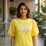 Women's yellow round neck top with sheer puff sleeves and embellished butterfly graphic (3)