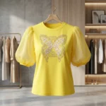 Women's yellow round neck top with sheer puff sleeves and embellished butterfly graphic (4)