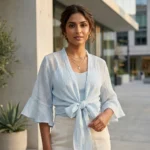 oman wearing a light blue tie front women's short shrug over a top (3)