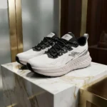 pair of Street Time white knitted mens running sneakers with black laces resting (4)