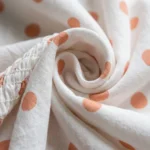 white round neck peplum top with peach polka dots and a smocked bodice (1)