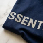 Man wearing a mens navy blue oversized essentials graphic t shirt (3)