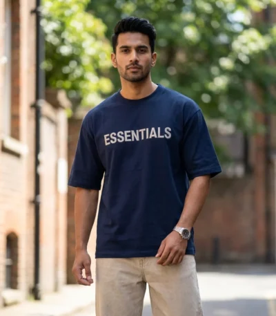 Man wearing a mens navy blue oversized essentials graphic t shirt (4)
