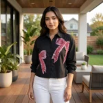 Women wearing a black crop shirt with pink beaded bow design (4)