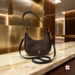 Coach shoulder bag is an iconic accessory featuring signature monogram print and refined black leather trim. – Classy coach shoulder bag – photo 1