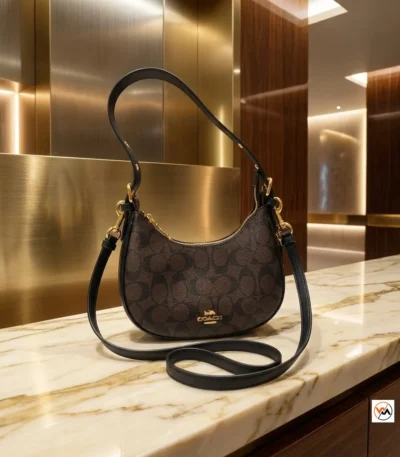 Coach shoulder bag is an iconic accessory featuring signature monogram print and refined black leather trim. – Classy coach shoulder bag – photo 1
