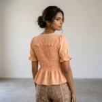 peach smocked peplum top with puff sleeves and pearl buttons (2)