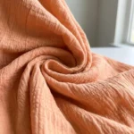 peach smocked peplum top with puff sleeves and pearl buttons (3)